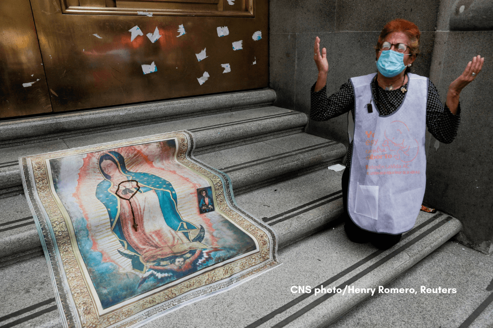 A woman prays outside the Mexico Supreme Court building in Mexico City July 29, 2020, while the court proposed to decriminalize abortion.