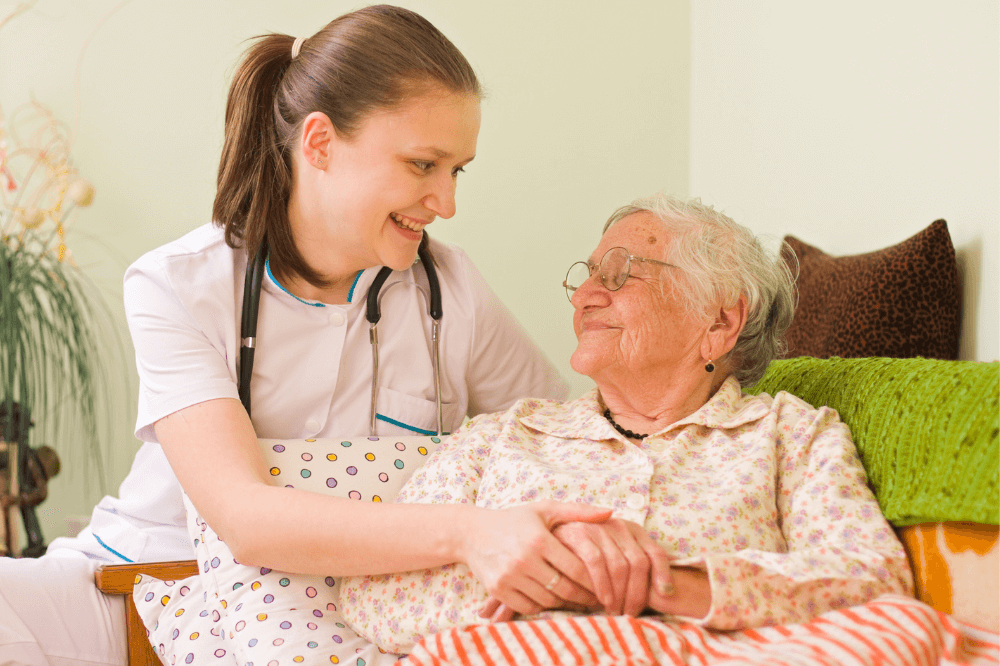 Young health care aide cares for elderly woman
