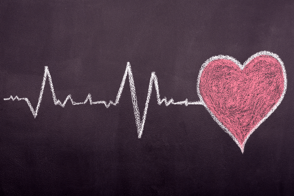 Heartbeat and heart image on chalkboard