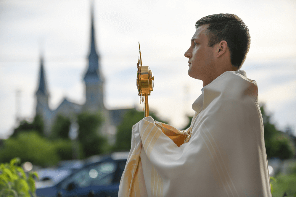 Father Jake Zemaitis holds the monstrance during eucharistic procession for the solemnity of the Sacred Heart of Jesus, June 7, 2024