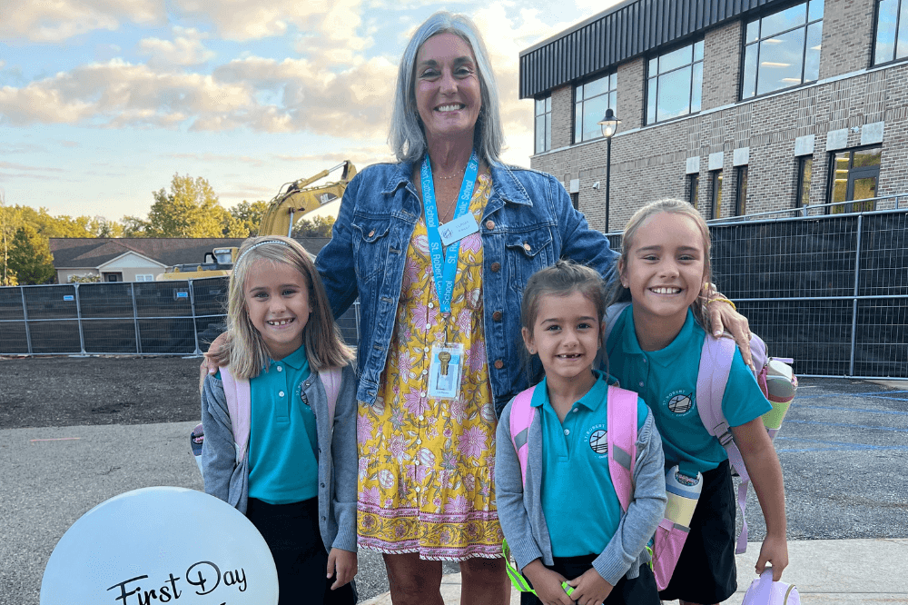 First Day of school at St. Robert Ada, 2024-25 school year. Principal Liz Peters with students