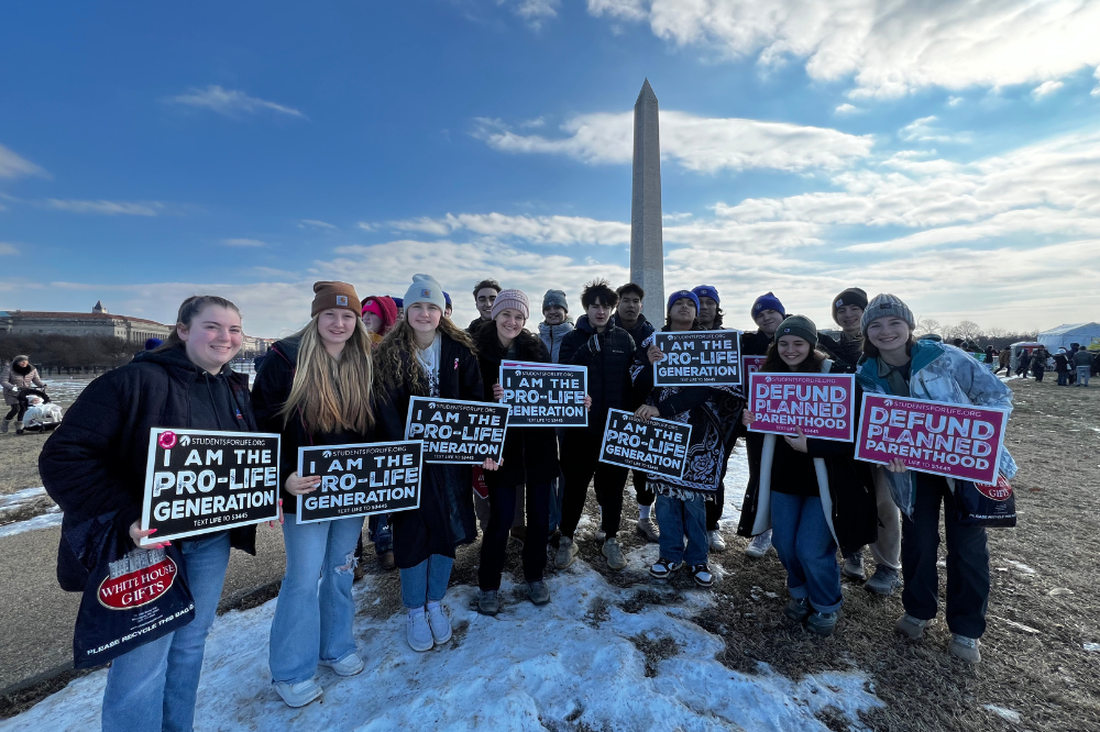 High schoolers from the Cluster parishes of St. Francis Xavier in Conklin, St. Joseph in Wright and St. Catherine in Ravenna gather with the Washington Monument in the background at the National March for Life in Washington, D.C. in January 2025.