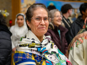 A Hispanic woman looks at the camera during the annual Our Lady of Guadalupe procession.