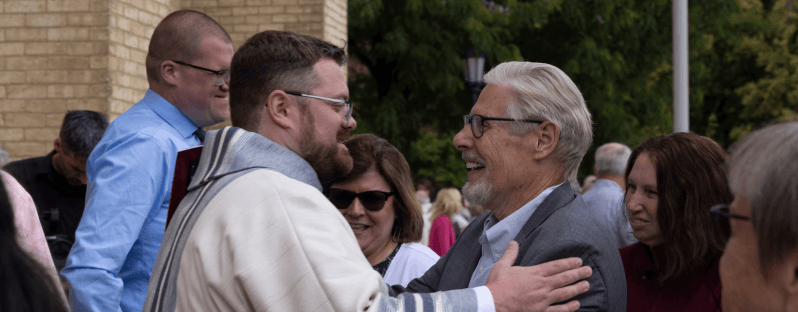Father Logan McGahan embraces a parishioner following his ordination on June 20, 2026.